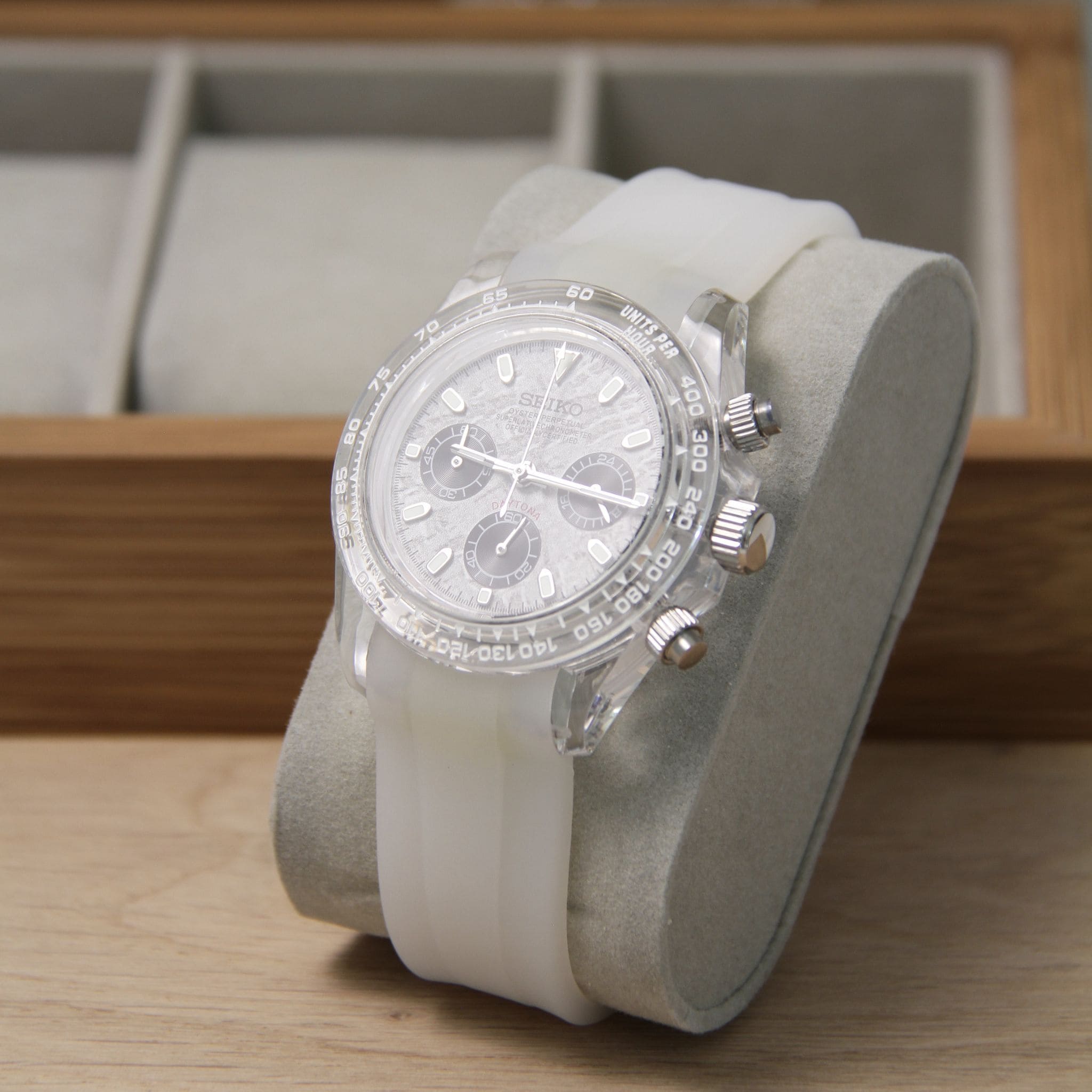 Montre Seiko mod daytona oysterflex gris vu de face sur coussin.