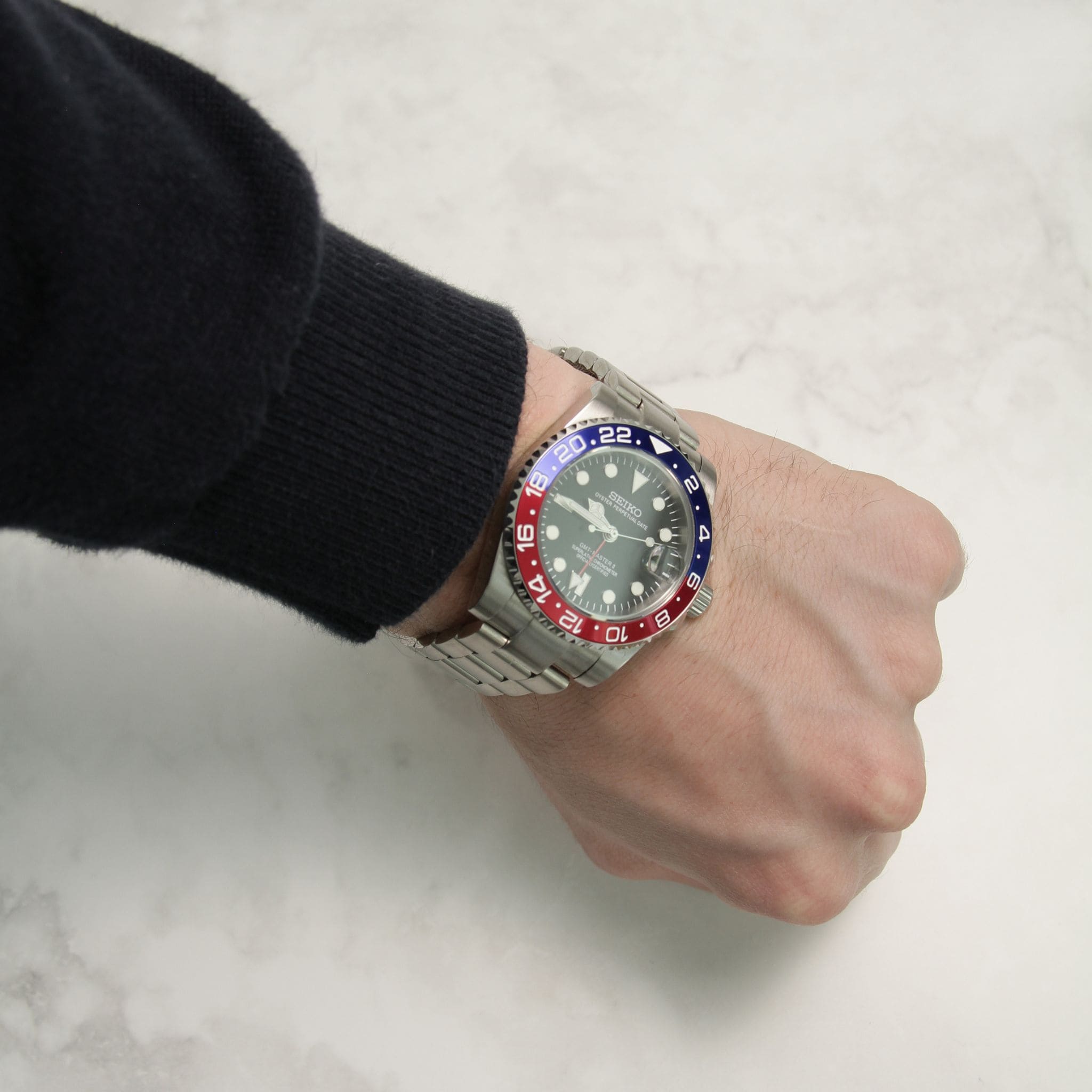 Seiko Mod GMT Pepsi portée au poignet – montre personnalisée sportive à lunette bleue et rouge.